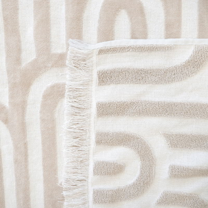 Detailed view of HiLo Arcade Sand Beach Towel featuring a elegant pattern, perfect for beach days and poolside relaxation, lightweight and quick-drying.