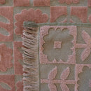 A detailed view of Hilo Bloom Toffee beach towel featuring floral designs, perfect for adding elegance to beach or pool outings.