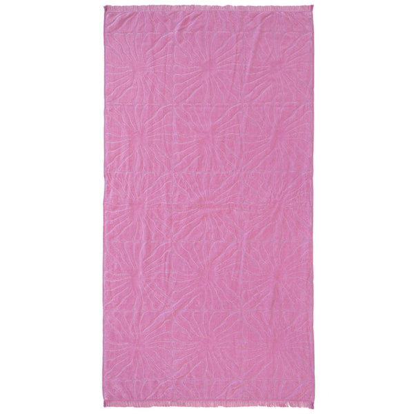 A vibrant pink beach towel featuring a floral pattern, perfect for beach days with its lightweight and quick-drying design.
