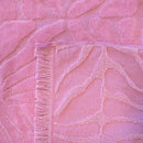 Detailed view of the vibrant pink beach towel featuring a floral pattern, perfect for beach days with its lightweight and quick-drying design.