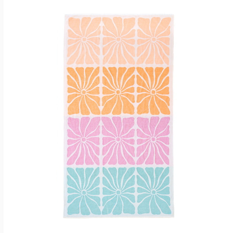 A bright Jacquard Stellata Beach Towel featuring a variety of colourful floral design.