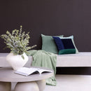 Jax Ocean cushion in blue and green velvet patchwork design on sofa

