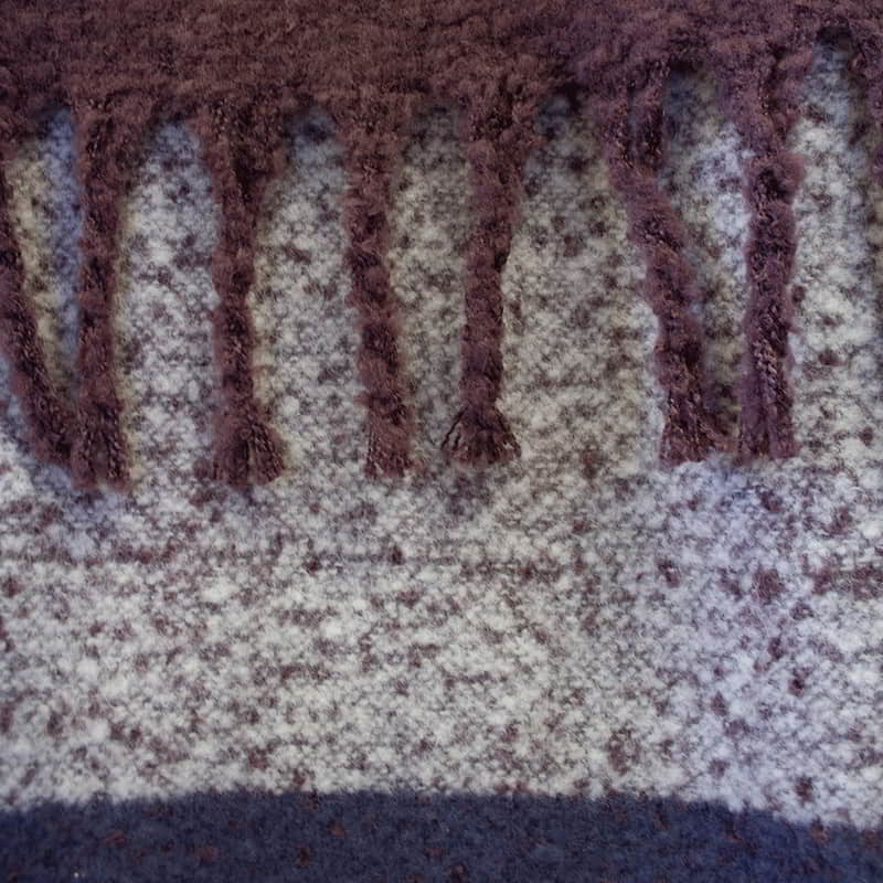 Detailed view of throw with fringes, beautiful colours in large check pattern, extra-long with tassels, soft like mohair, machine washable.