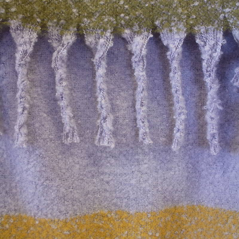 Detailed view of purple and yellow throw with fringes, beautiful colours in large check pattern, extra-long with tassels, soft like mohair, machine washable.