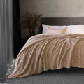 Bambury Lattice Sherpa Latte Blanket styled across a bed in a cosy modern bedroom