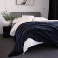 Bambury Lattice Sherpa Navy Blanket styled across a bed in a cosy modern bedroom