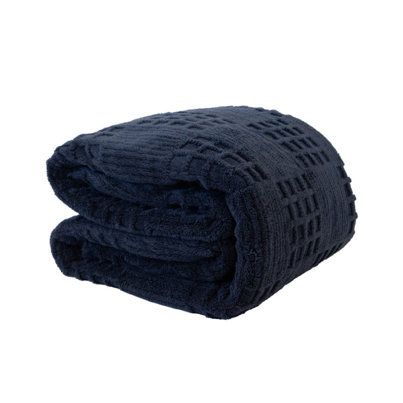 Folded navy sherpa blanket showing thickness and soft finish