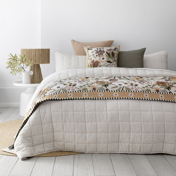alt="A cosy bedroom with durable and soft microfibre fabric with quilted checks, neutral colour for layering with cushions and throws, offers a cloud-like appearance and extra warmth"