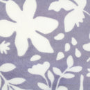 Detailed shot of luxurious blue blanket with a two-tone floral pattern, super soft and silky fabric, perfect for adding warmth to the bed. Machine washable.