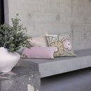 Lulu Taupe Cushion styled with blush and neutral cushions on concrete bench

