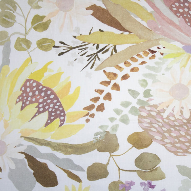 alt="Close-up view of a hand-painted, digitally printed quilt cover designed with a smaller scale floral print on the reverse inspired by the striking foliage of Australian flora"