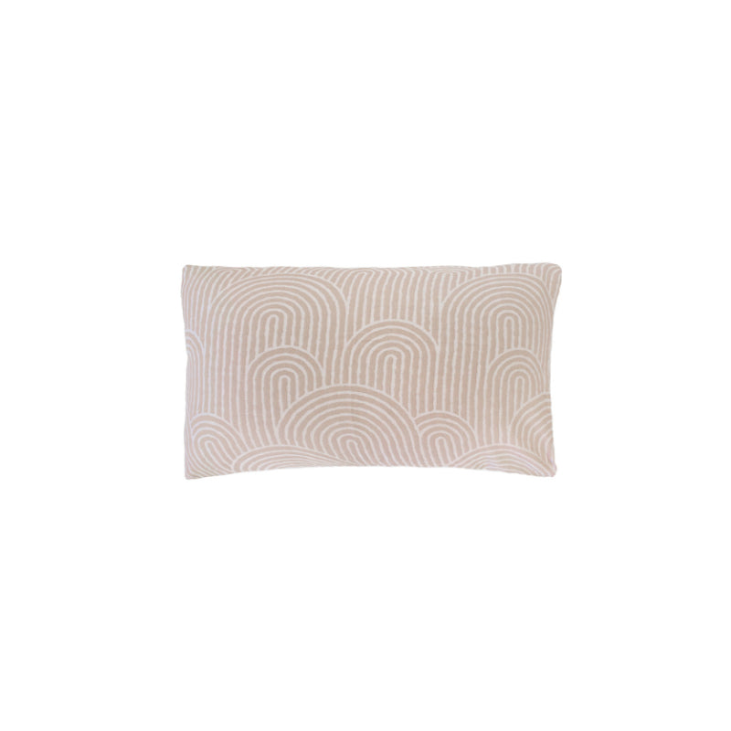 A stylish pillow featuring a brown design, enhancing the cosy atmosphere of a beautifully decorated bedroom.