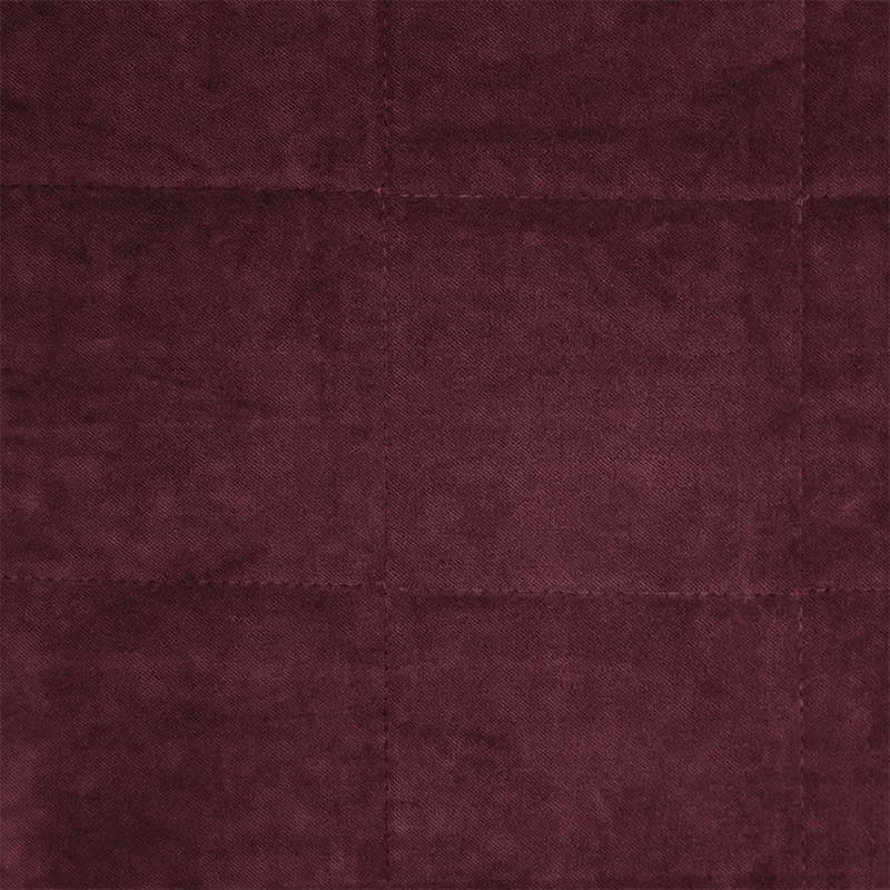 Detailed view of a luxurious maroon cushion features gorgeous cotton velvet with quilted square pattern.