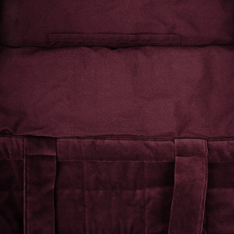 Inside detail of a large burgundy tote bag made from sumptuous cotton velvet featuring a quilted square pattern, cotton lining, and a pocket.
