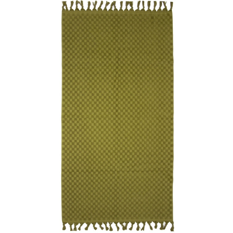 alt="A stylish moss green beach towel with a small check pattern achieved through a series of high and low sections of towelling finished with a beautiful fringe along the ends"