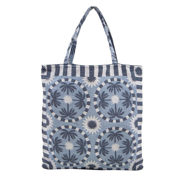 alt="A light blue and dark blue designed with palm tree pattern tote bag"