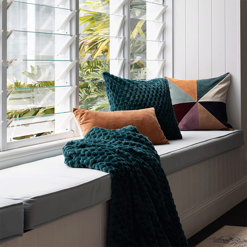 Luxuriously soft teal throw with fluffy pile, checkers pattern, and coordinating plain reverse side on any setting.