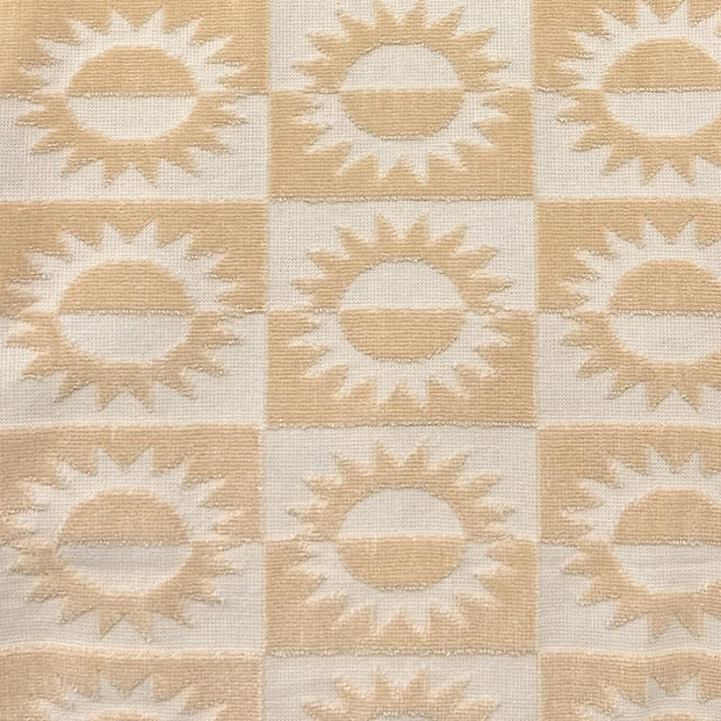 alt="Close-up view of a yellow beach towel featuring a stylish sun pattern with knotted tassels on both ends"
