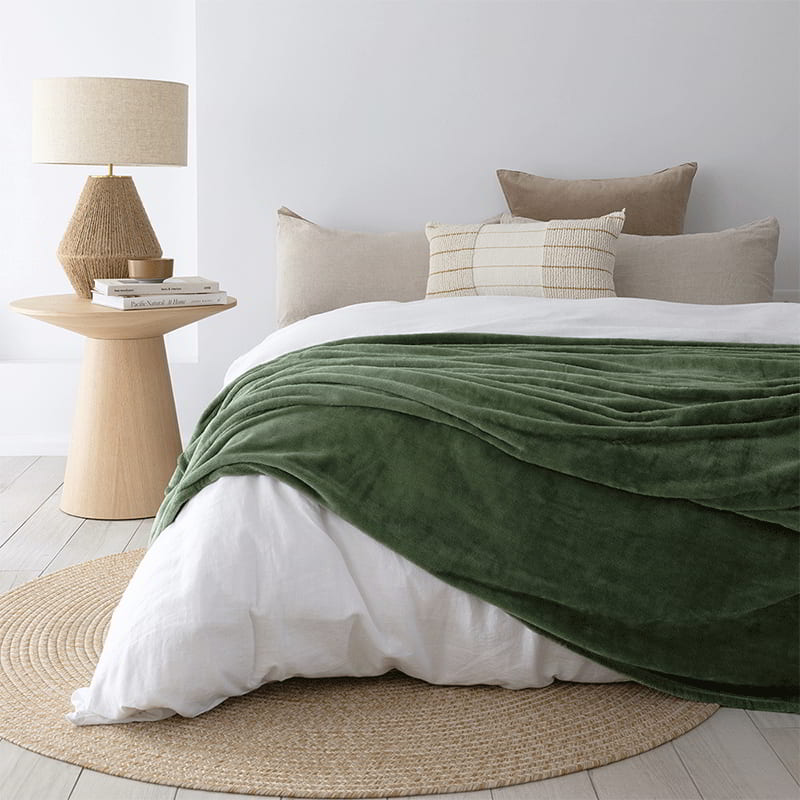 Luxuriously soft green blanket from Bambury, perfect for adding warmth to your bed or snuggling up while relaxing on the couch.
