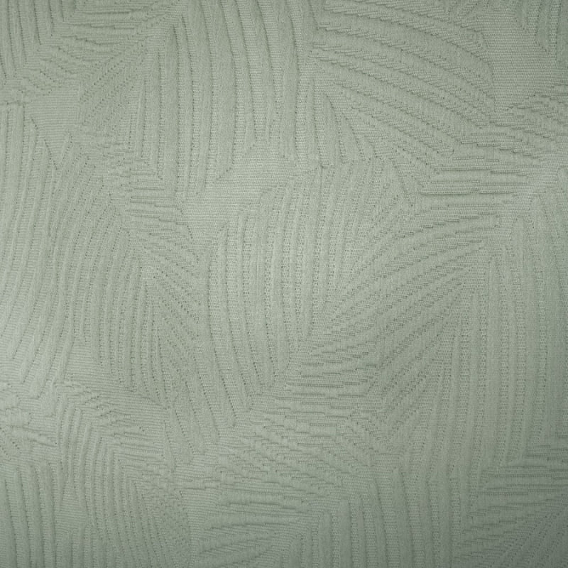 alt="Close-up view of a soft green tones fabric  featuring a subtle textural leaf pattern"