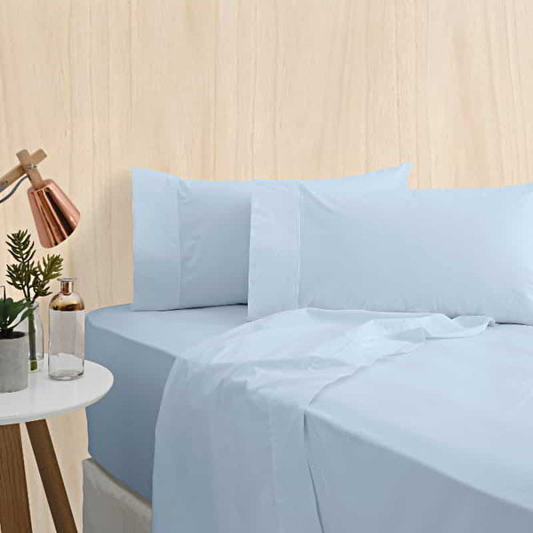 alt="A powder blue bamboo cotton sheet set featuring its minimal, inviting softness and comfort in a cosy bedroom set-up"
