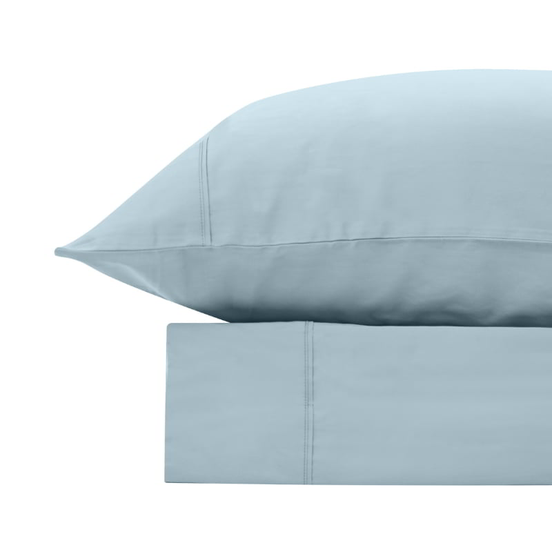 alt="A powder blue bamboo cotton sheet set featuring its minimal, inviting softness and comfort"