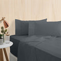 alt="A charcoal bamboo cotton sheet set featuring its minimal, inviting softness and comfort in a cosy bedroom set-up"
