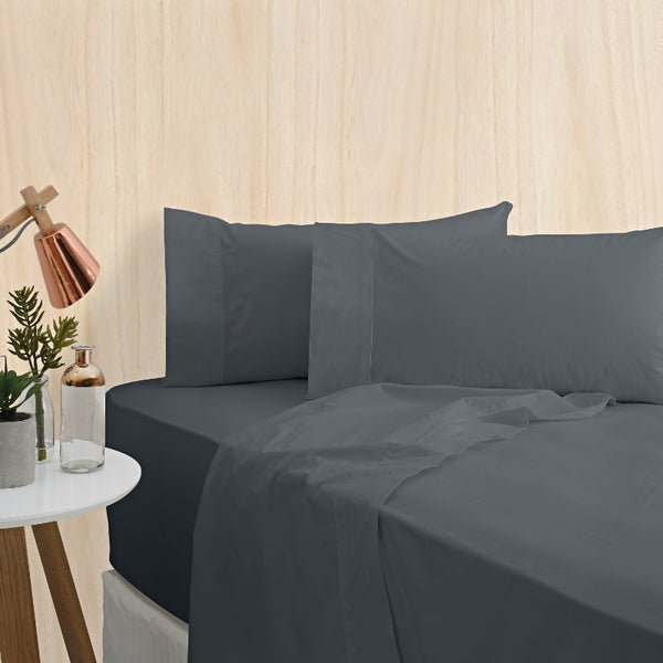 alt="A charcoal bamboo cotton sheet set featuring its minimal, inviting softness and comfort in a cosy bedroom set-up"