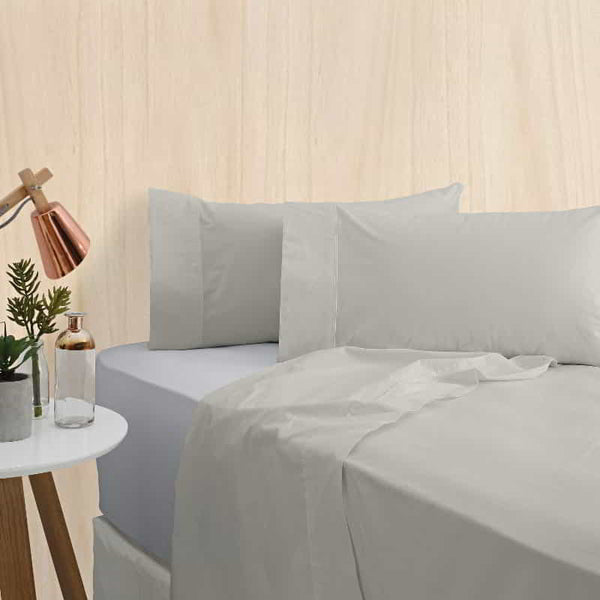 alt="A silver bamboo cotton sheet set featuring its minimal, inviting softness and comfort in a cosy bedroom set-up"
