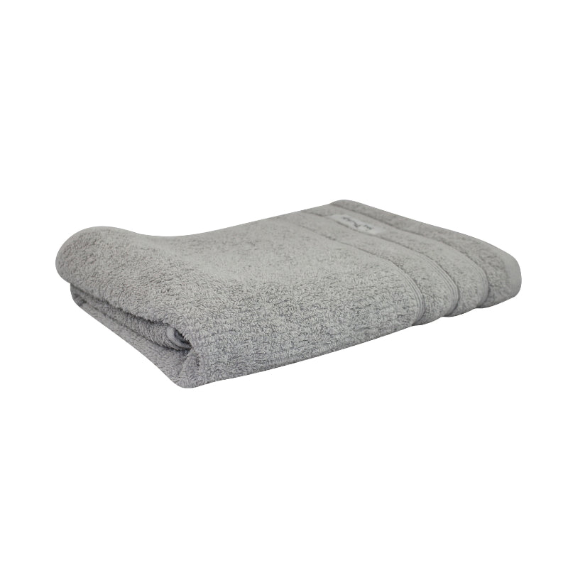 alt="Actual folded details of pebble Bath towel featuring its finest Egyptian cotton and high level of softness."