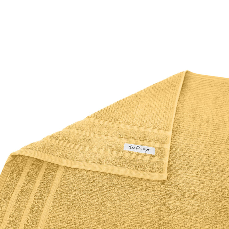 alt="An elegantly folded premium yellow hand towel, showcasing its minimal and soft details"