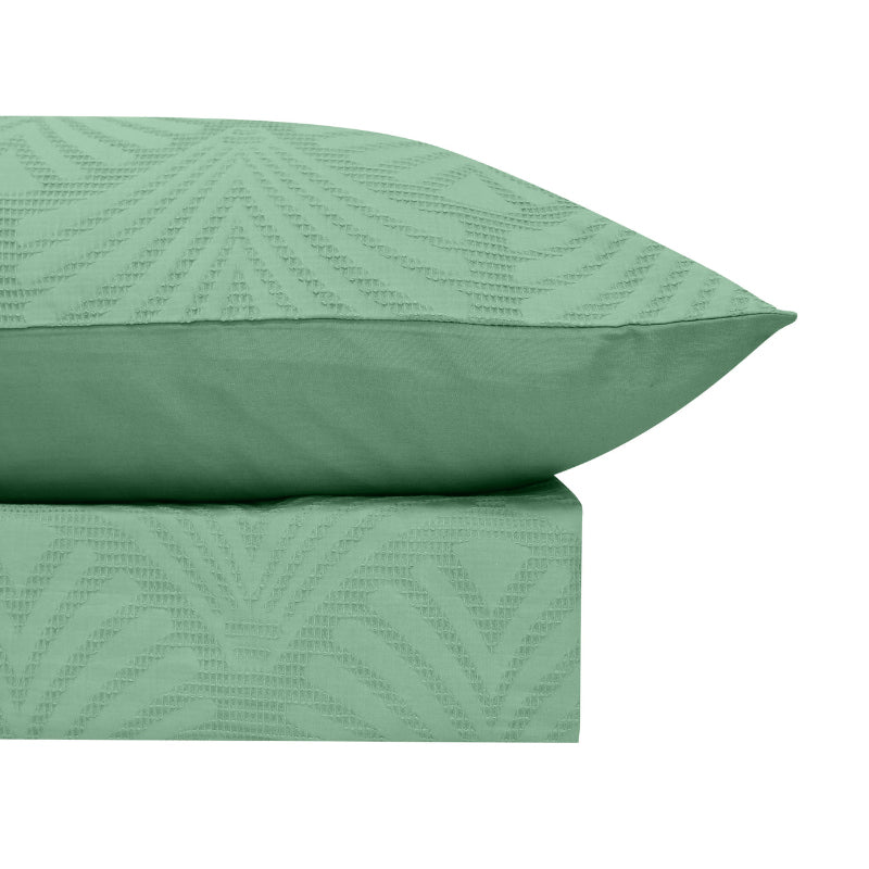 alt="Luxurious quilt cover set available in green hue featuring a subtle yet elegant design along with the pillowcases"