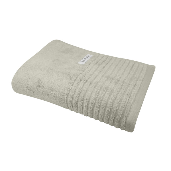 alt="A full photo details of a neatly folded oatmeal hayman bath towel showcasing its premium-quality zero twist cotton and inviting softness"