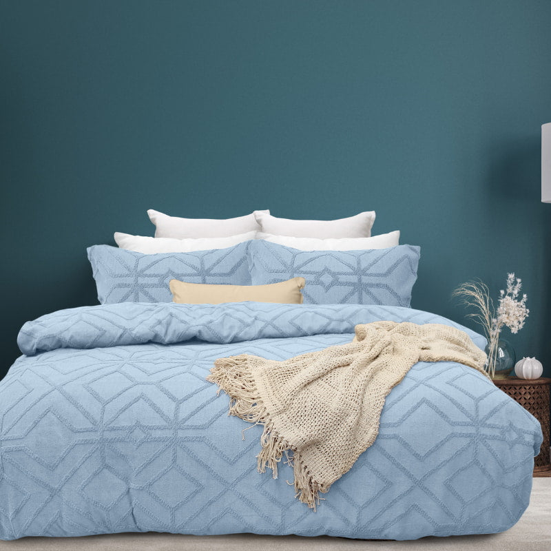 alt="Luxurious quilt cover set in a blue hue features a captivating geometric design matching with the throw and pillowcases"