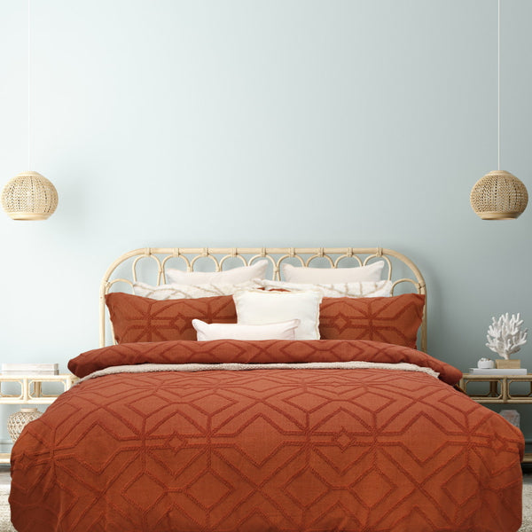 alt="Luxurious quilt cover set in an orange hue features a captivating geometric design matching with the pillowcases"