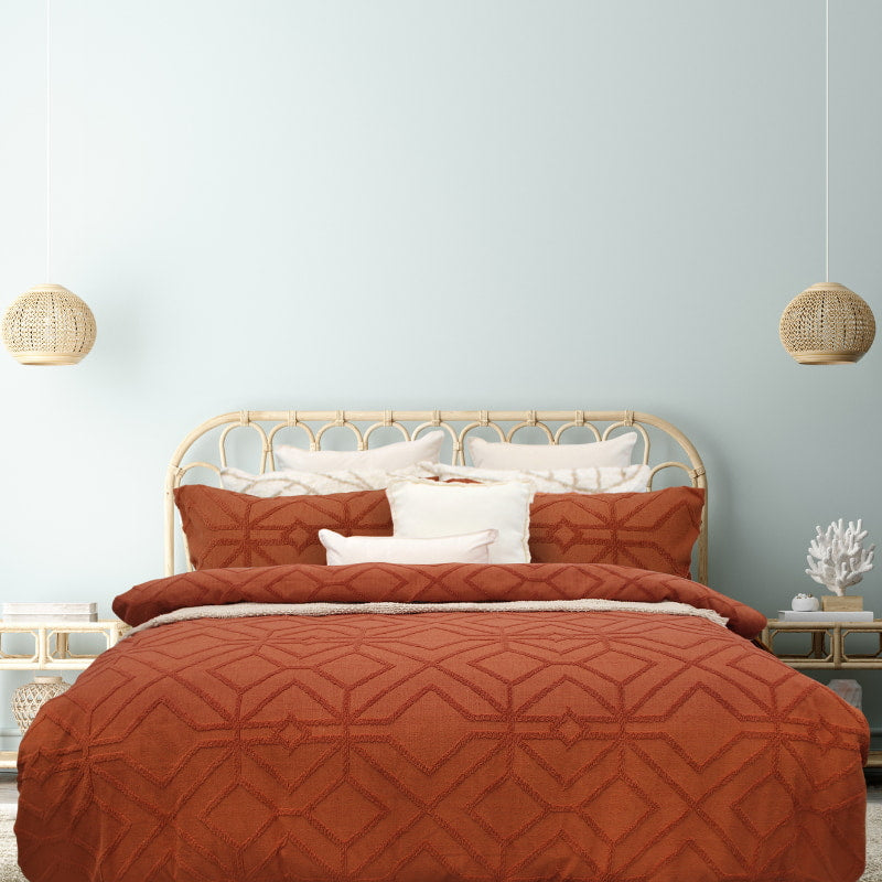 alt="Luxurious quilt cover set in an orange hue features a captivating geometric design matching with the pillowcases"