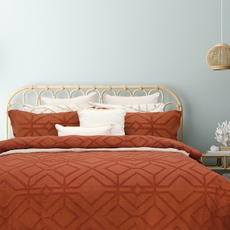 alt="Luxurious quilt cover set in an orange hue features a captivating geometric design matching with the pillowcases"