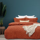 alt="Luxurious quilt cover set in an orange hue features a captivating geometric design matching with the throw and pillowcases"