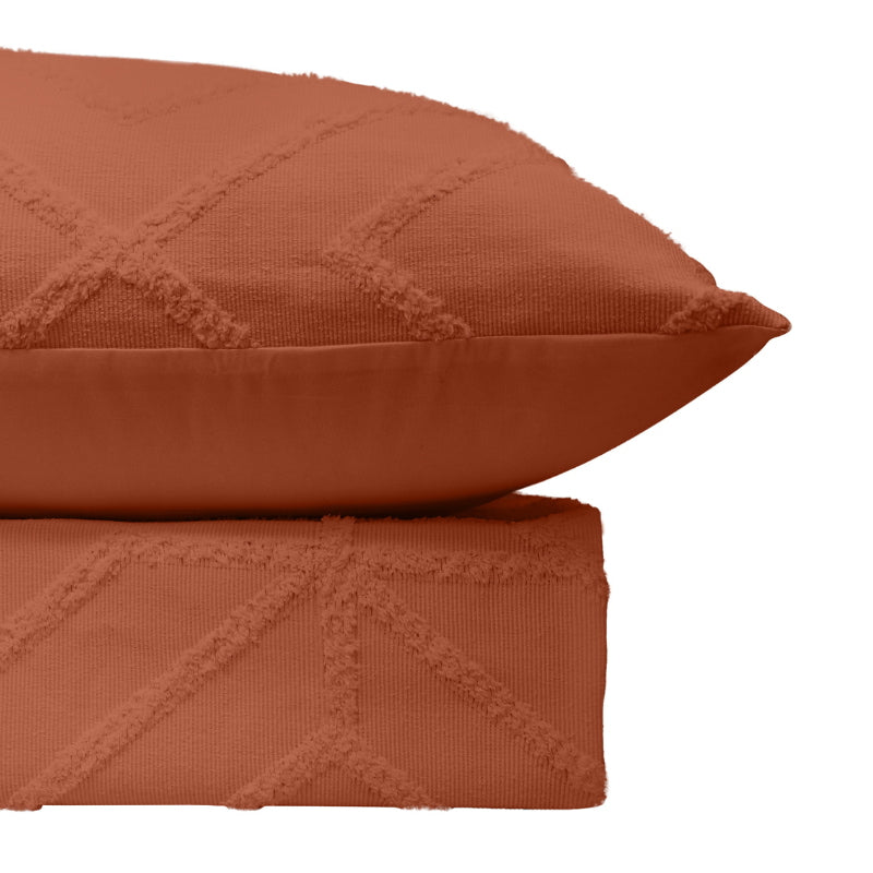 alt="Luxurious quilt cover set in an orange hue features a captivating geometric design with pillowcases"