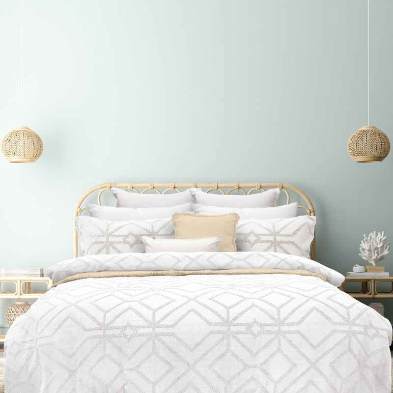 alt="Luxurious quilt cover set in a white hue features a captivating geometric design matching with the pillowcases"