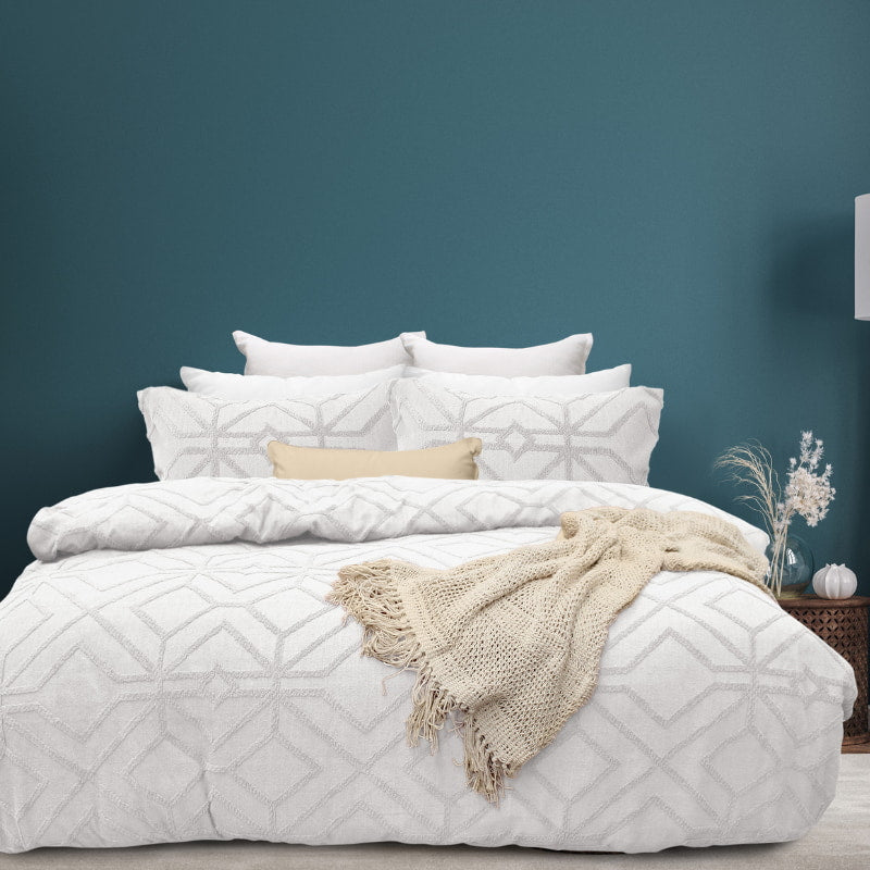 alt="Luxurious quilt cover set in a white hue features a captivating geometric design matching with the throw and pillowcases"