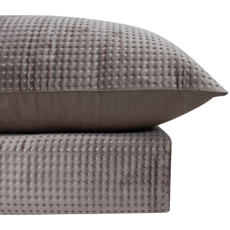 alt="Luxurious quilt cover set in a brown hue will add cosiness to your bedroom."