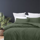 alt="A luxurious quilt cover set in a green hue will add cosiness to your bedroom."