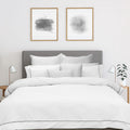 alt="Soft pure cotton quilt cover set in white hue featuring an elegant border details"