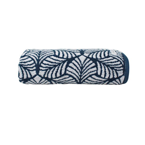 alt="A neatly rolled palm cove bath towel in riviera blue colour showcasing its luxurious details and premium-quality cotton"