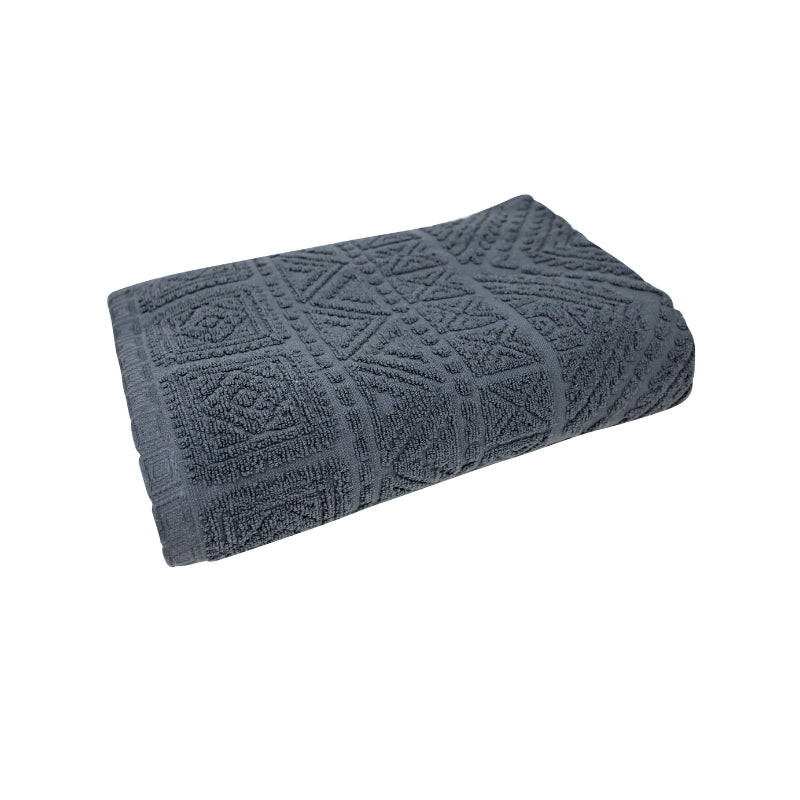 alt="A zoom-in photo of a neatly folded charcoal persia bath towel showcasing its luxurious design"