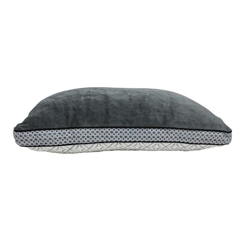 alt="View from a reclined angle of a memory foam pillow features a cosy velvet cover"