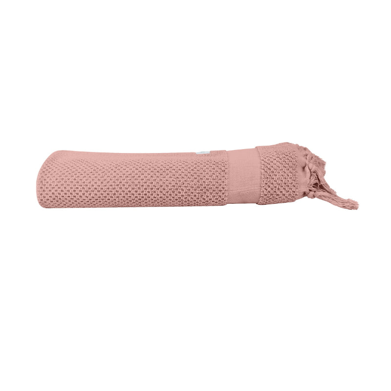 alt="An elegantly folded pink hand towel, showcasing its minimal and soft details"