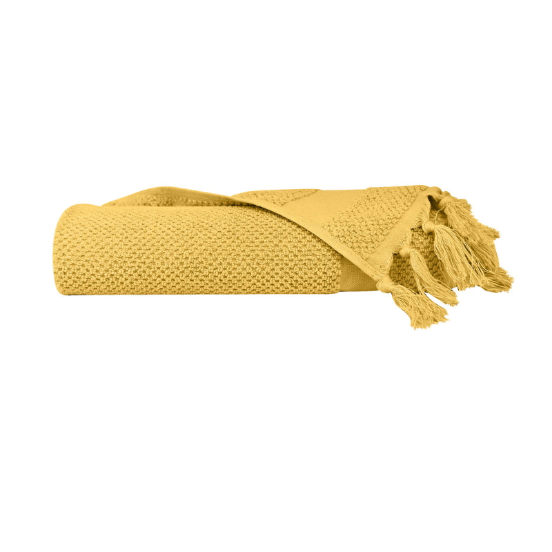 alt="An elegantly folded premium yellow hand towel, showcasing its minimal and side details"