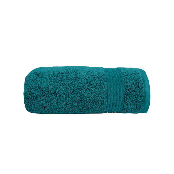 alt="A neatly rolled teal valencia zero twist towel featuring its soft and intricate details."
